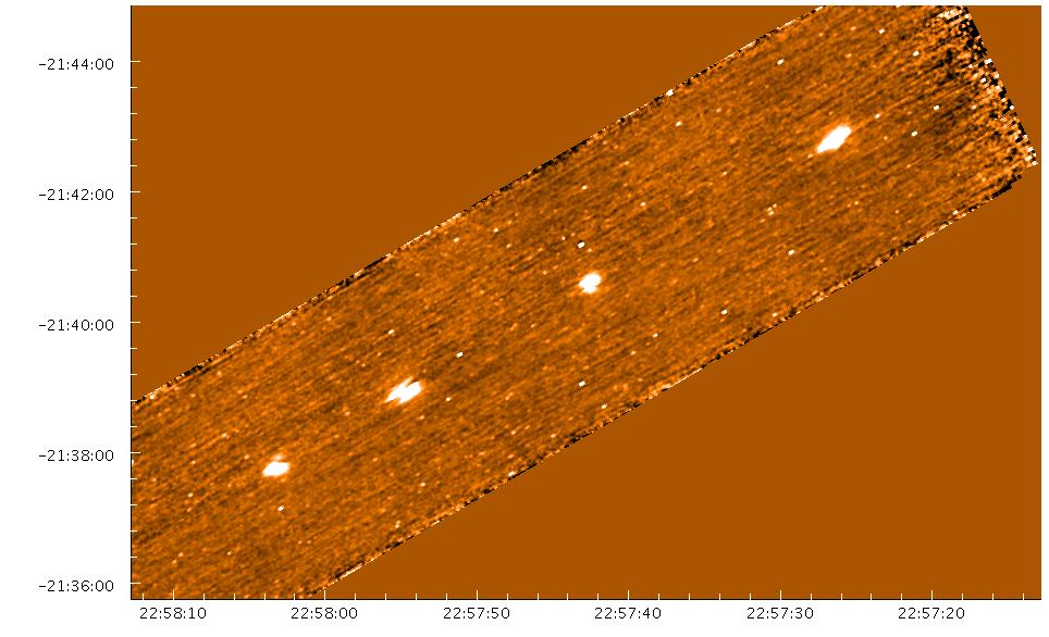 An illustrative example of a case where a fixed time observation was essential. Asteroid 2005 YU55 crossed the PACS field of view so fast that it could only be observed by scanning along the path of the asteroid in the sky, at a fixed time when the asteroid was predicted to pass through the field of view. The asteroid was captured once on each scan leg, giving an image on the frame for each scan that were then combined to produce the final image. This is the 70 micron map in sky coordinates.
