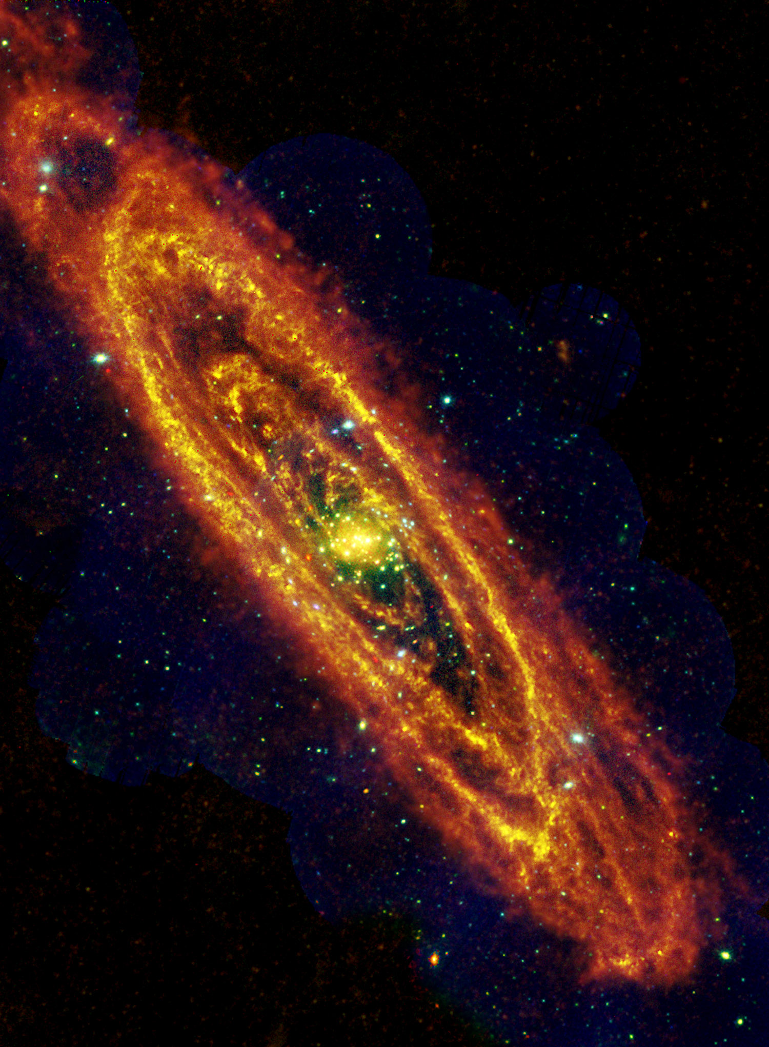 M31's once and future stars. A combined Herschel and XMM-Newton (x-ray) image of M31 showing dusty star-forming regions (Herschel) and the point-sources that represent highly evolved stars (XMM-Newton). The Herschel data were taken at 250 microns with SPIRE between 17 and 21 December 2010. In the XMM-Newton RGB image, red sources are those that have soft x-ray spectra, dominated by low-energy x-ray emission; these are normally low-mass x-ray binaries, while the blue sources are sources with hard x-ray spectra, dominated by high-energy emission, which are high-mass compact binaries with a neutron star, or black hole secondary. This image contains what is effectively a snapshot of the star formation history of M31 and its two satellite galaxies, M32 (superimposed on the spiral arm below the nucleus of M31) and M110 (very faintly visible in the Herschel image to the top right). Whereas M110 is essentially a dying galaxy, with only a tiny residual of star formation and no massive stars at all, M31 is very much alive and boiling with star formation activity in the dark rifts between its spiral arms.