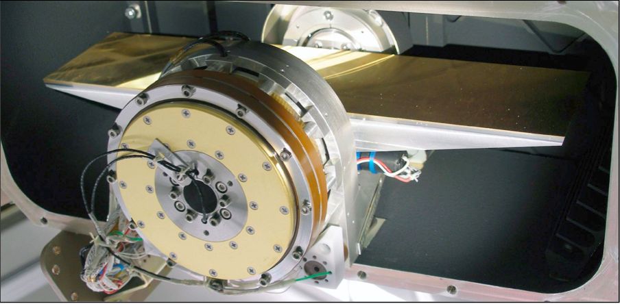 Flight model grating unit. A torquer motor is used to actuate the grating angle which is measured with sub-arcsecond precision by an inductosyn angular resolver.